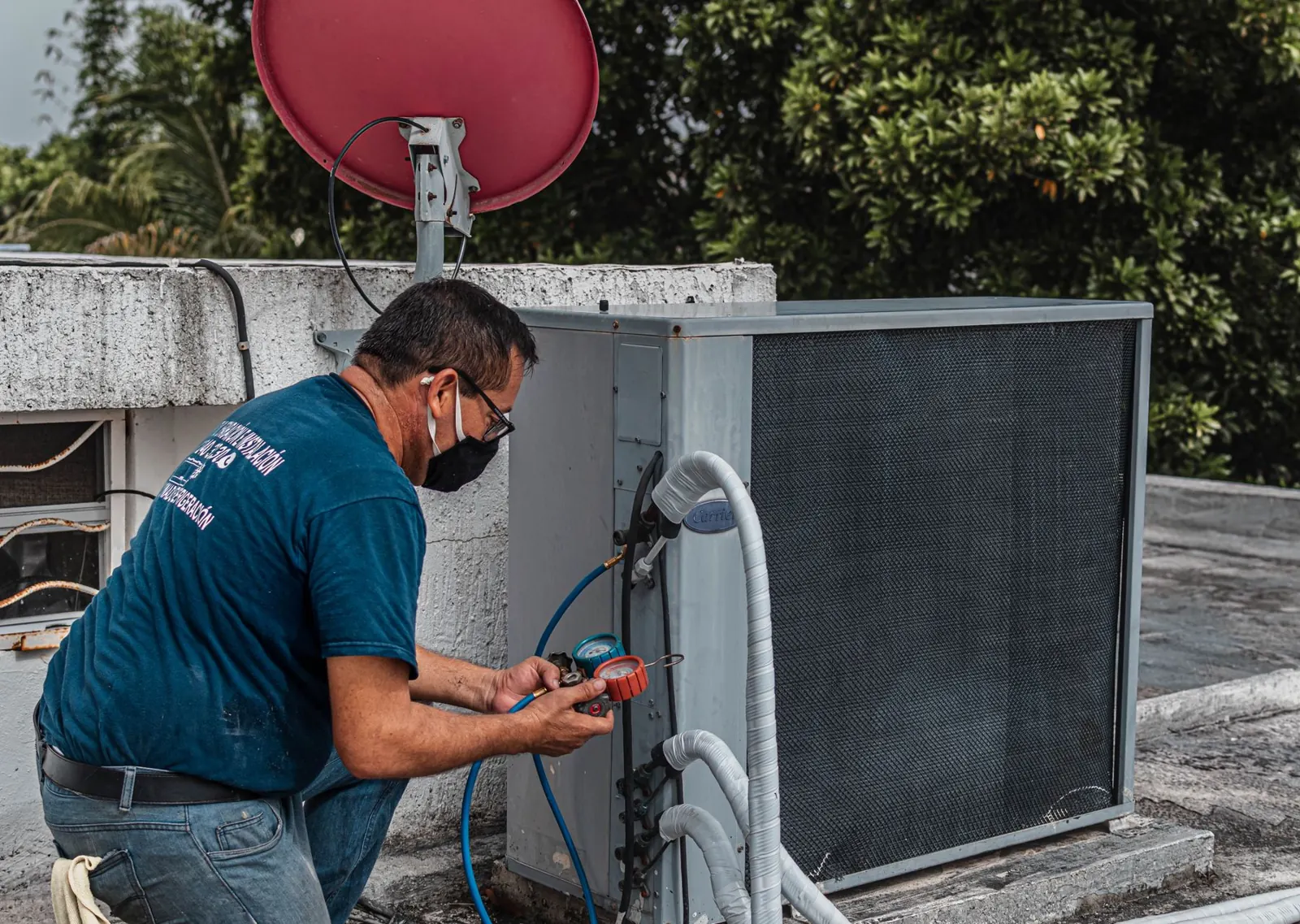 An engineer commissioning an air conditioning unit with pressure gauges
